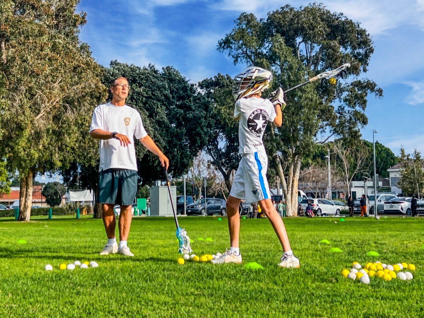 Dan Murray coaching a Sessions Lacrosse player